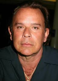 Fate smiles ...... those who untiringly grapple with stark realities of  life. A. with B. over C.