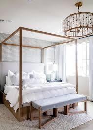 Beautiful Stained Wooden Canopy Bed Beside A Light Gray Headboard Finished With A Blue Velvet Bench At The Foot Of Wooden Canopy Bed Bed Design Canopy Bedroom