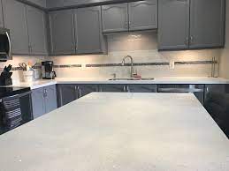 White Sparkle Quartz Countertops With Ikea Grey Cabinets Perla Street Tile With Chrome Accent Tile Quartz Kitchen Countertops Kitchen Marble Quartz Countertops