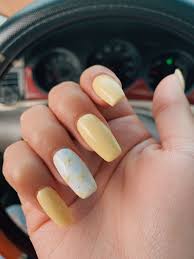28 celebrity light yellow nail polish photos steal her style. Pastel Yellow Nails With One White Finger With Yellow Daisies And Some Silver On It As Well Yellow Desig Yellow Nails Design Yellow Nails Pastel Nails Designs