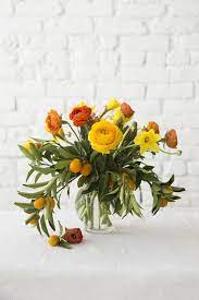 Designlovefest The Flowers Used For This Project Tulips Lilacs Ranunculus Daffodils Feverf With Images Beautiful Flower Arrangements Flower Arrangements April Flowers