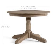It has a metal base with a unique accent ring. Owen Round Pedestal Extending Dining Table Pottery Barn
