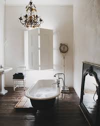 Crisp white subway tile , black and white patterned floor tile, elegant sculptural vanities and mirrored armoire. 7 Vintage Bathrooms Style And Function Town Country Living