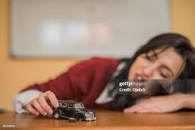 Young Woman Playing With A Car Toy High-Res Stock Photo