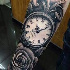 This tattoo image shows an eye with a pupil clock. Amazing Black Ink Pocket Watch With Rose Tattoo Design For Forearm
