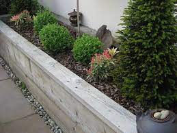 Raised Timber Sleeper Plant Border With A Concrete Block And Rendered Wall Behind Finished With Copin Patio Garden Design Retaining Wall Design Sleeper Garden