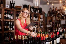 Female small business owner using tablet computer while working in wine shop - CAVF15901 - Cavan Images/Westend61