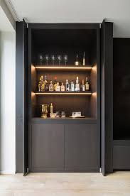 This wine cabinet in antique finish is a stylish and convenient addition to any bar area. These Home Cocktail Bar Ideas Are Perfect For The Party Season