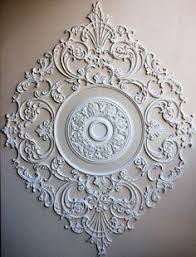 Use alone or combine with mouldings and woodcarvings to create an even greater focal point. 8 Put A Medallion On It Ideas Ceiling Design Plaster Ceiling Ceiling Medallions