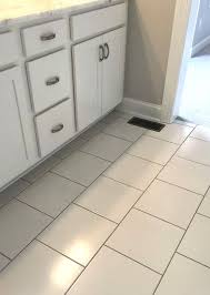 White 12 X 12 Floor Tile With Black Grout In Offset Installation Pattern Floor Tile Grout Bathroom Flooring Tile Floor
