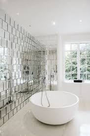 Mirrored Wall Tiles Add A Touch Of Modern Glamour To This Minimalist Bathroom The Reflection Takes Bathroom Interior Design Bathroom Interior Bathroom Design