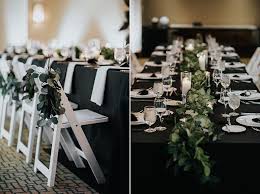 Black And White Table Decorations This Simple Black White Table Decor Is Adorned With A Greenery To Add A Natural Feel Image Black Wedding Decorations Black Tablecloth Wedding Wedding Table