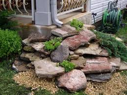 Make A Rock Waterfall By Stacking Flat Rocks Under The Gutter You Create A Waterfall Effect Onc Porch Landscaping Backyard Landscaping Front Yard Landscaping