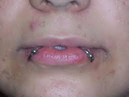 Also known as a venom piercing, a snake eyes piercing is when a horizontal piercing goes across the tip of the tongue, with a barbell going all the way through the width of the tongue. Snake Bites Piercing Risks Aftercare And Jewelry Advice Hubpages