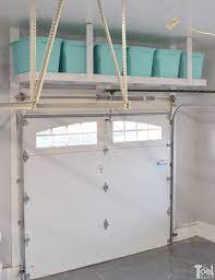 It provides a clever, innovative way to hang light to medium items directly from your garage ceiling and then lower them down when necessary. Overhead Garage Storage Shelf Her Tool Belt