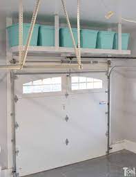 This storage solution is simple to make using several 2 x 4s and mounting them to the wall studs with long screws. Overhead Garage Storage Shelf Her Tool Belt