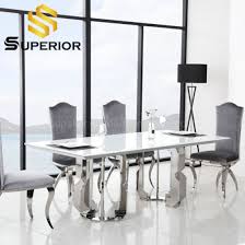 Each piece is supported by a strong wooden base in salvage dark oak, contrasting the flawless white marble table top and beige color upholstered chairs with nailhead trim detail. China 2020 New Arrival Mexico Luxury White Marble Dining Room Tables China Dinner Table Dining Table Set