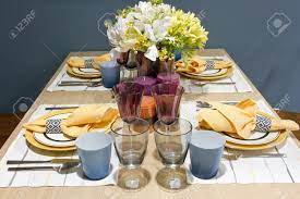 To set a casual table, you'll need a place mat, dinner plates, soup bowls, salad plates, napkins, dinner forks, knives, soup spoons, water glasses, and wine glasses. Dinner Table Setup Stock Photo Picture And Royalty Free Image Image 15354570