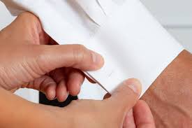 Step 1 hold the cuff between your thumb and index finger as you put it through the holes. How To Wear Cufflinks And Studs 5 Simple To Follow Steps Jfw