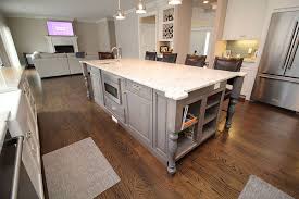 Oak countertops on white cabinets in a kitchen pantry accented with nickel pulls and a gray and white speckled backsplash finish. Kitchen Island Inspiration Images And Ideas