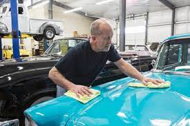 Don't waste time looking for a car body repair shop to do the job, as it could be weeks before they can service your vehicle. Two Caucasian Male And Female Car Mechanics At Work On A Car In A Classic Car Repair Shop Stockphoto