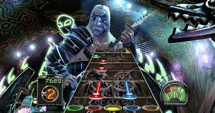 Cristen conger standing in front a television screen with your plastic axe str. Party Like A Rock Star With Guitar Hero Iii