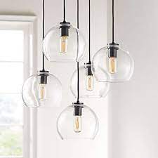The updated open frame is formed with sleek square steel tubing, and each pendant is a generously proportioned, minimalist silhouette completed in either textured blacksmith or heirloom bronze finishes. Entryway Lighting Fixtures Pendants Lamps More Crate And Barrel