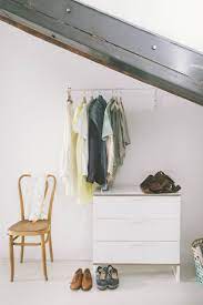 Marder used two of these ikea clothes racks, which sit underneath a long, wooden mounted shelf held up by a few of their white ekby brackets. Ikea Mulig Clothes Bar 18 90