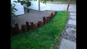 Fill in the trench, and tamp the soil gently to settle the border in place. Diy Backyard Outdoor Wood Edging Landscaping Youtube