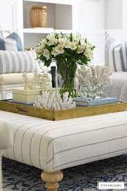 Summer Styled Upholstered Ottoman With Fresh Florals And Layered Coral Sculptures Is The Perfect Vignette For Summer Living Room Summer Living Room Decor Decor