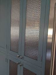 The door features a metal mesh insert for a unique look and modern touch. The Short List Current Cabinetry Obsessions Dlghtd Kitchen Cabinet Doors Cabinet Doors Decor