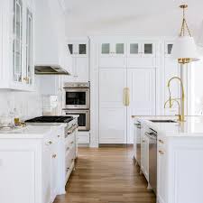 The stainless steel appliances also take a back seat to the brass accents yet offer a sleek and timeless cooking space. Trim Moldings On Refrigerator Doors Transitional Kitchen