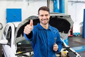 Smiling Mechanic Looking At Camera At The Repair Garage Stock Photo, Picture And Royalty Free Image. Image 36349333.