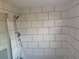 Contemporary black and white black ceramic floors and black window frames appear perfectly with white bathroom tiles that dominate the area. Mum Uses 8 Screwfix Black Grout To Transform Boring White Bathroom Tiles And People Say The Results Are Stunning
