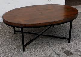 Oval Dark Brown Polished Wooden Coffee Tables With Four Black Metal Legs On Grey Floor Dark Wood Coffee Table Oval Wood Coffee Table Coffee Table Wood