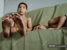 Maybe you would like to learn more about one of these? Innocent Children Seat And Lying Down On The Couch With Dirty Feet Inside Copy Space Stock Photo 274302000