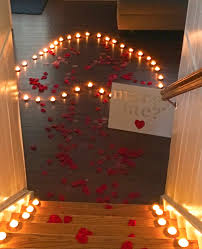 The Moment She Ll Never Forget A Romantic At Home Proposal With Rose Pedals And Candl Romantic Proposal Candlelit Proposal Marriage Proposal Ideas Romantic