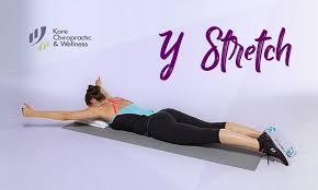 Y Stretch Start By Lying Facedown On Mat With Your Forehead Resting On A Folded Towel So Yo Physical Rehabilitation Rehabilitation Chiropractic Wellness