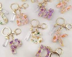 dried flower initial keychain crystal quartz resin keychain etsy in 2021 keychain how to make rings custom keychain