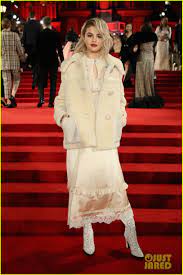 She finished her look with ruched black leather thigh high boots. Selena Gomez Zendaya Are Blonde Bombshells At Fashion Awards 2017 Selena Gomez Outfits Selena Gomez British Fashion Awards