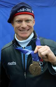 World Class Athlete SPECIALIST Doug Sharp, USA, shows off his newly awarded  bronze medal for the men's four-man bobsled event after a 2002 WINTER  OLYMPIC GAMES medal ceremony in Salt Lake City -