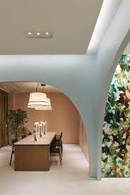 The Interior Of Maison Lexia In Osaka Features Arched Walls In Pastel Hues And A Dis Showroom Interior Design Commercial Interior Design Interior Design Awards