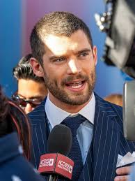 Superman co-stars #DavidCorenswet and #NicholasHoult are having a white  tank and grey sweater face-off! Who wore it better? 😂 📷: DavidCorenswet