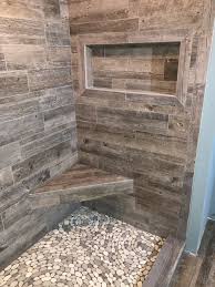 Plank Tile Shower Walls River Rock Pebble Shower Pan W R Jones Tile Stone West Bend Wi Farmhouse Shower Stone Shower Floor Shower Tile