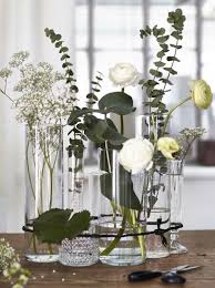 For A Modern Twist On The Traditional Flower Arrangement Group A Variety Of Clear Glass Vases With Randomly Place Ikea Wedding Vases Decor Flower Arrangements