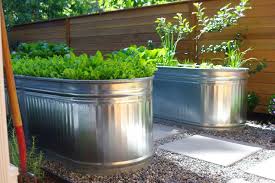 Speaking of stock tank tubs, what if you were to have one of these things placed inside your bathroom? How To Turn A Stock Tank Into A Planter For Edibles And More