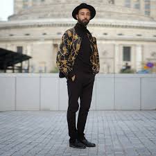 Black And Gold Bomber Jacket Mens Men S Black And Gold Print Bomber Jacket Black Turtleneck Black Chinos Black Leather Brogues Leather Jacket Men Mens Outfits Wide Brim Hat Outfit