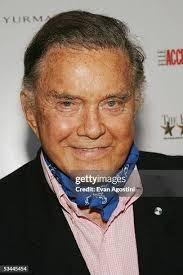 American actor Cliff Robertson wears a tuxedo as he holds colleague... News  Photo