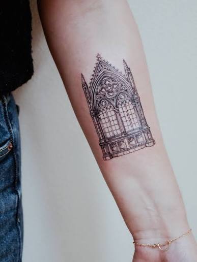 A gothic window tattoo for the souls who love dark elegance and whispered-in-stone architecture. Fine-line arches, stained-glass symmetry, and that classic gothic silhouette—this design is for anyone who keeps a little cathedral