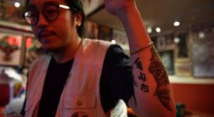 From umbrellas and Chinese calligraphy, to gas masks and helmets; Hong Kong  protesters get inked